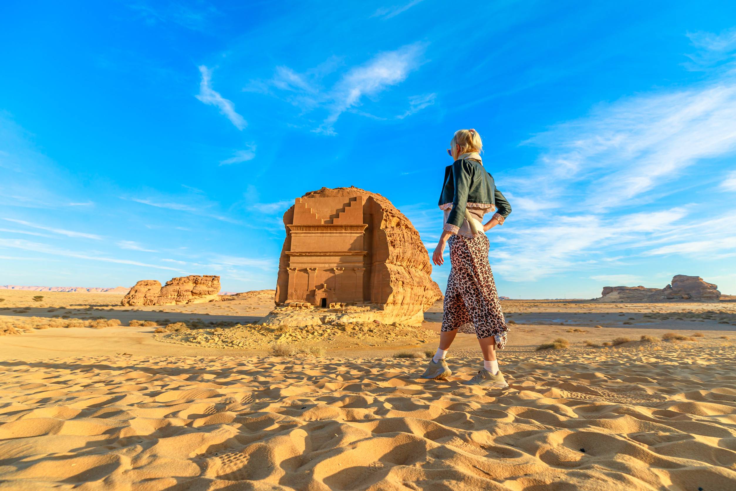 blonde Tourist Walking In The Desert Admiring The Monumental Qasr Al Farid A Solitary Nabatae blonde Tourist Walking In The Desert Admiring The Monumental Qasr Al Farid A Solitary Nabatae