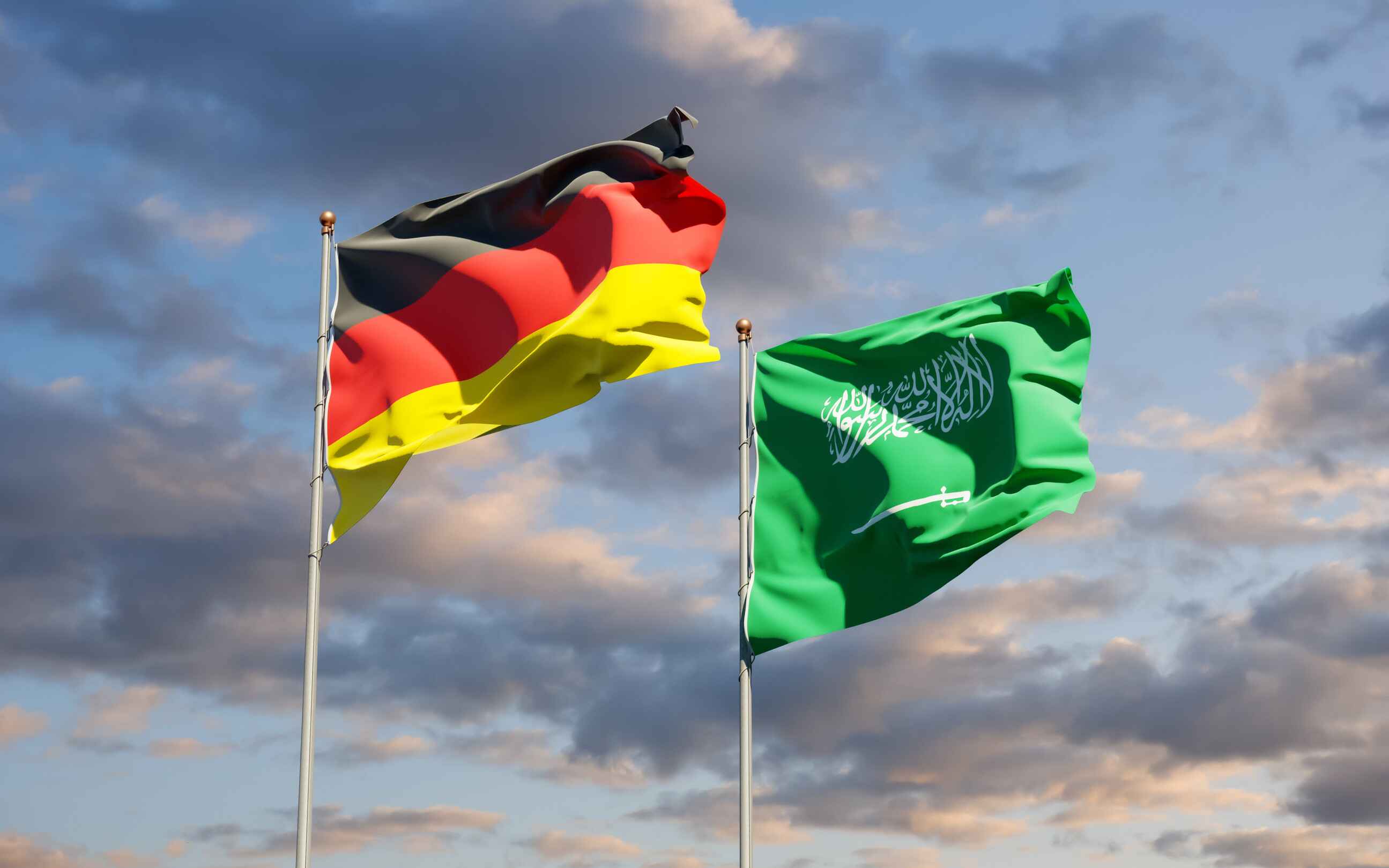 German And Saudi Flags Waving Together