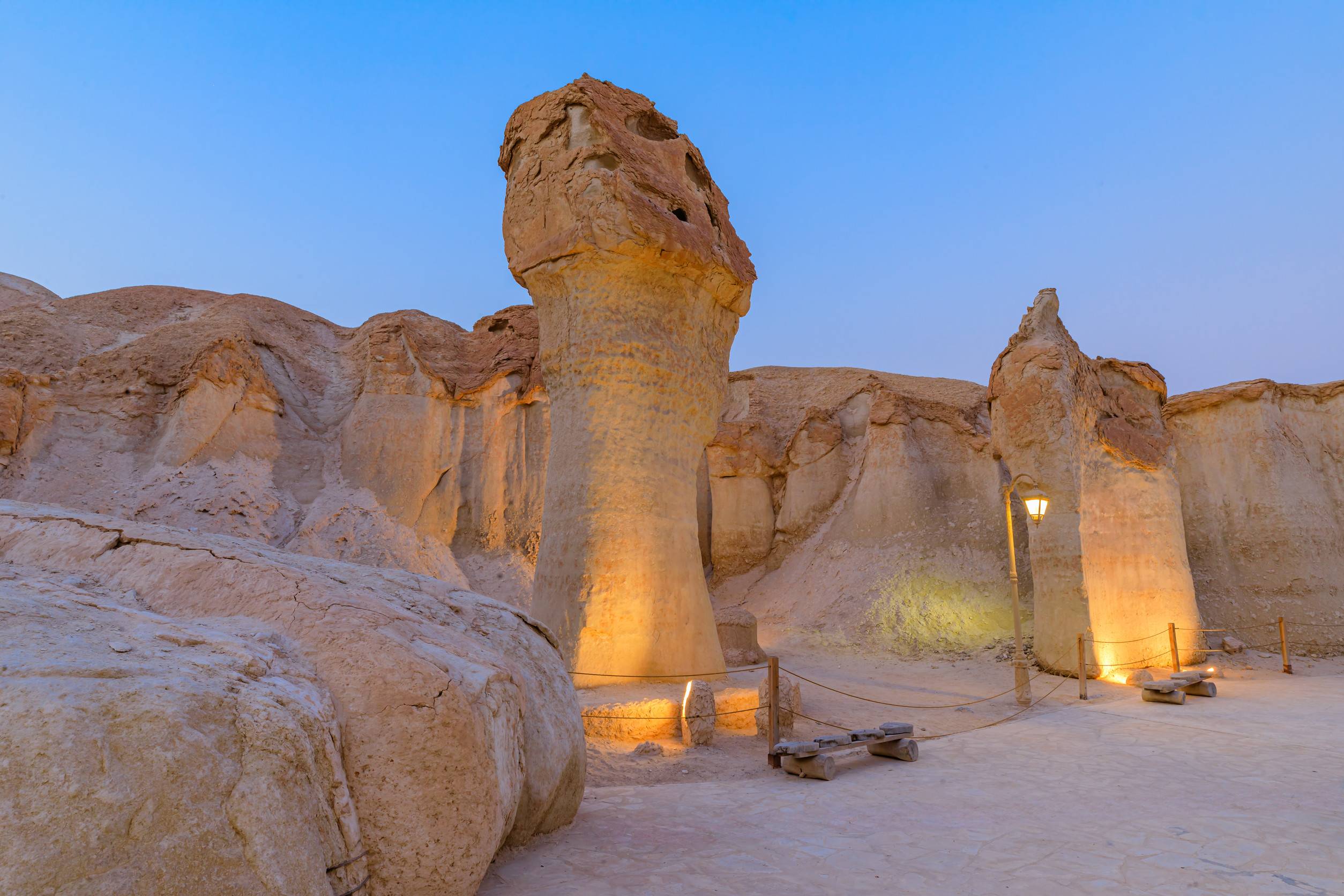 Soft Evening Light Illuminating Sandstone Formations And Walking Path Inside Jabal Al Qarah Mountain Soft Evening Light Illuminating Sandstone Formations And Walking Path Inside Jabal Al Qarah Mountain