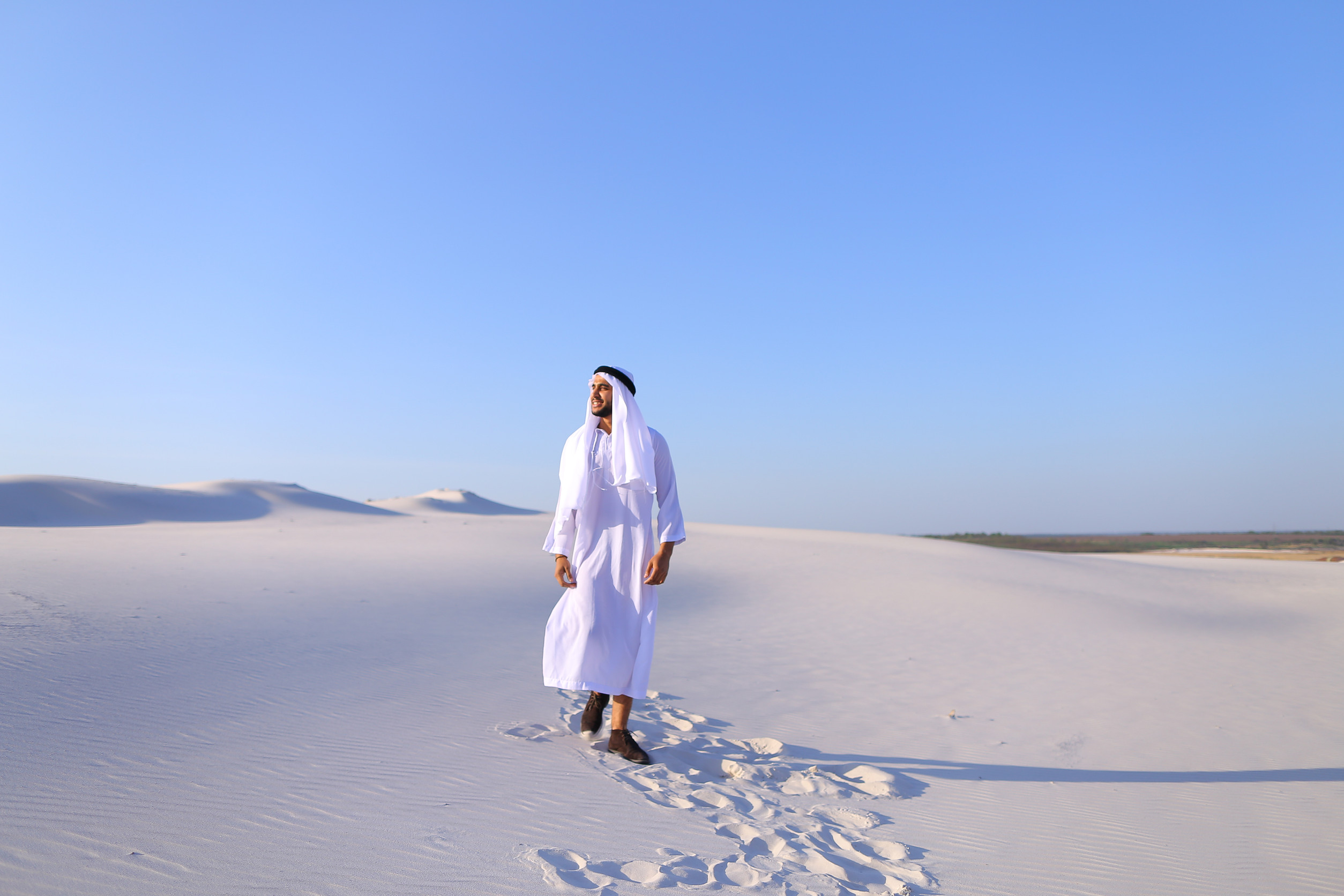 Stately Young Sheikh Walks On Foot Along Bottomless Desert Leaving Traces On Sand Enjoying Warm Stately Young Sheikh Walks On Foot Along Bottomless Desert Leaving Traces On Sand Enjoying Warm